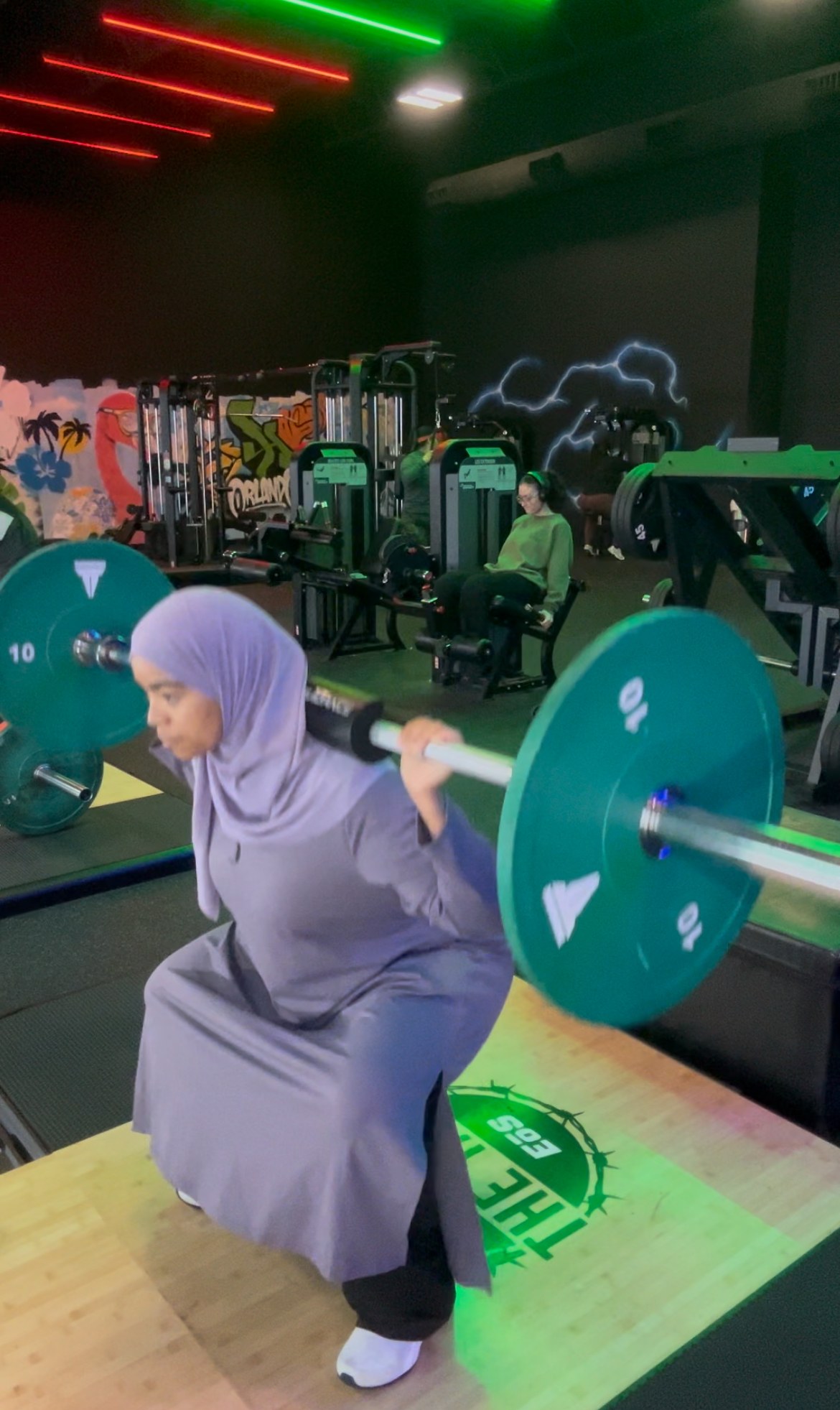Close view of Coach Assia holding the bottom position of a barbell squat